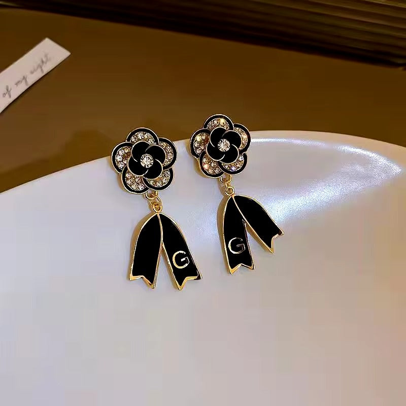 FS-ERS9NC - Black Camelia Bow Letter Earrings